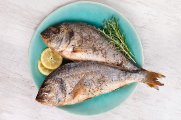 Poster - Grilled sea bream on plate, top view.