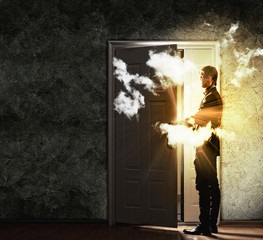 Wall Mural - Young businessman opening door