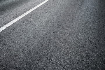 Detail of asphalt road with white line