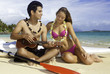 © tomas del amo - couple on beach with ukulele