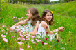 children friends girls on spring poppy flowers meadow