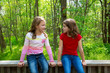 children friend girls talking on the jungle park forest