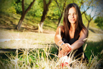 Portrait of the young beautiful smiling woman outdoors, enjoying