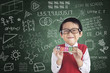© Creativa Images - Cheerful boy student holding LEARN block