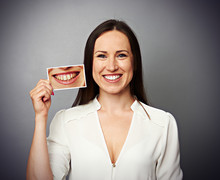 Woman Holding Picture With Yellow Teeth