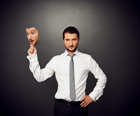 Canvas Print - man holding mask with amazed face