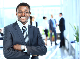 Confident business man with his team behind