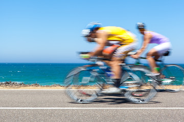 Cyclists competing along a coastal road