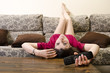 © FotoAndalucia - Girl lying facedown watching television alone.