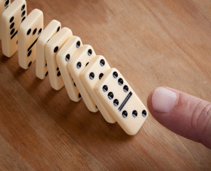 Finger pushing domino pieces