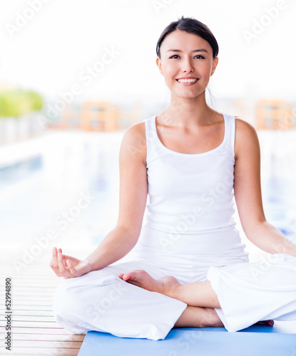 Woman practicing yoga - 52994890