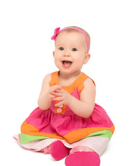 Wall Mural - happy little baby girl in bright multicolored festive dress isol