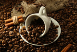 Fototapeta Mapy - Cup with coffee beans, close up