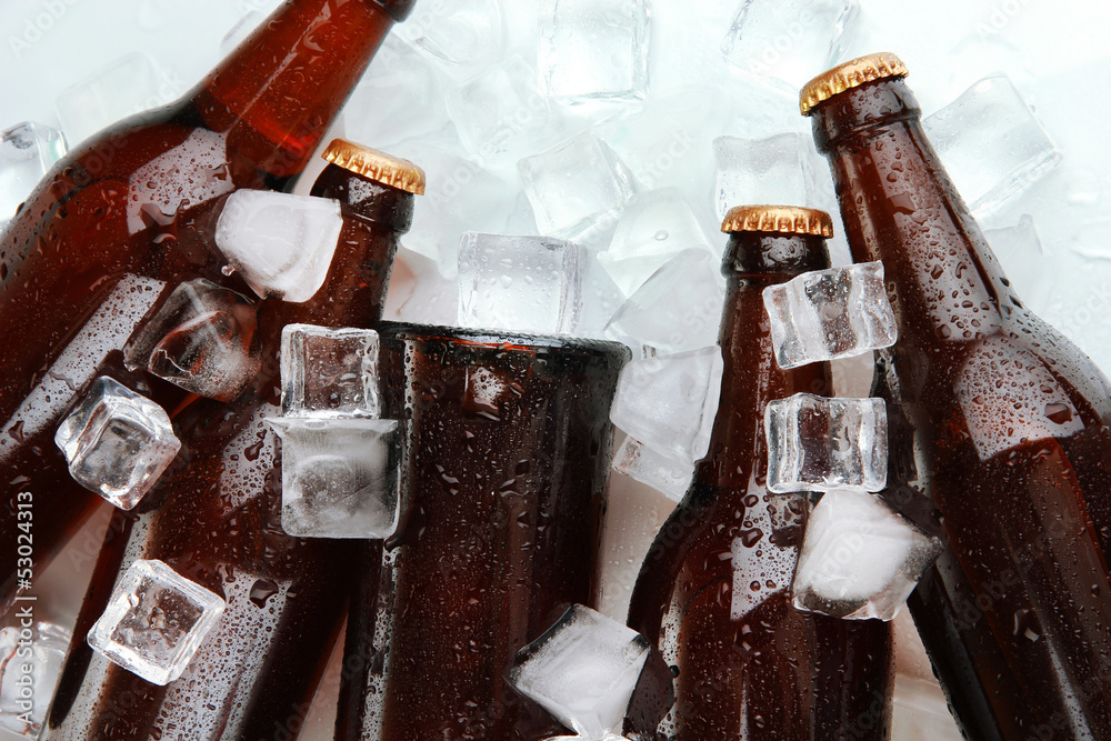 Beer bottles in ice cubes close up