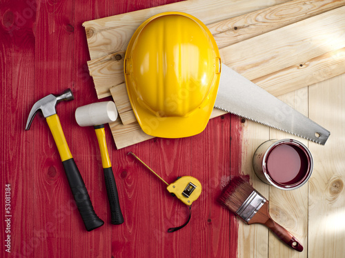 Fotografia, Obraz red wood floor with a brush, paint, hammer and yellow helmet