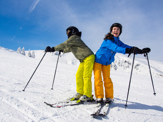 Wall Mural - Teenage girl and boy skiing