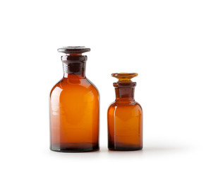 Small chemical glass bottles on white background