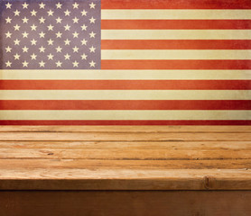 Empty wooden deck table over USA flag background