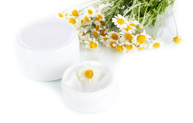 Cream with chamomile isolated on white