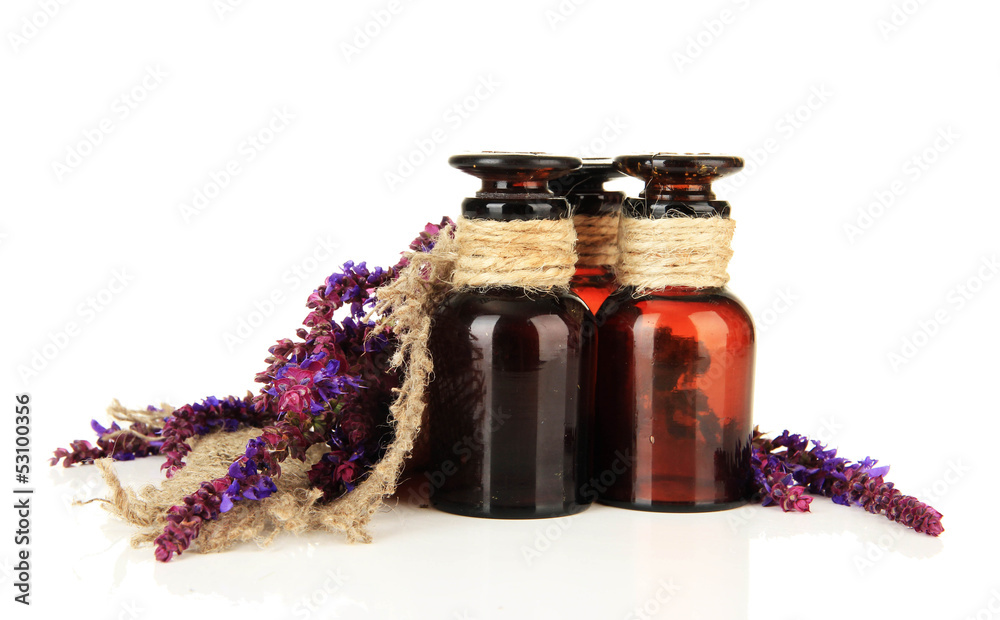 Medicine bottles and salvia flowers, isolated on white