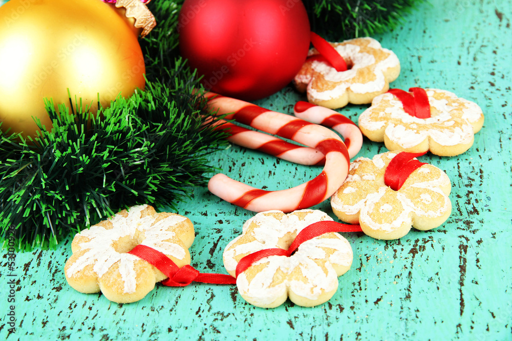 Christmas cookies and decorations on color wooden background