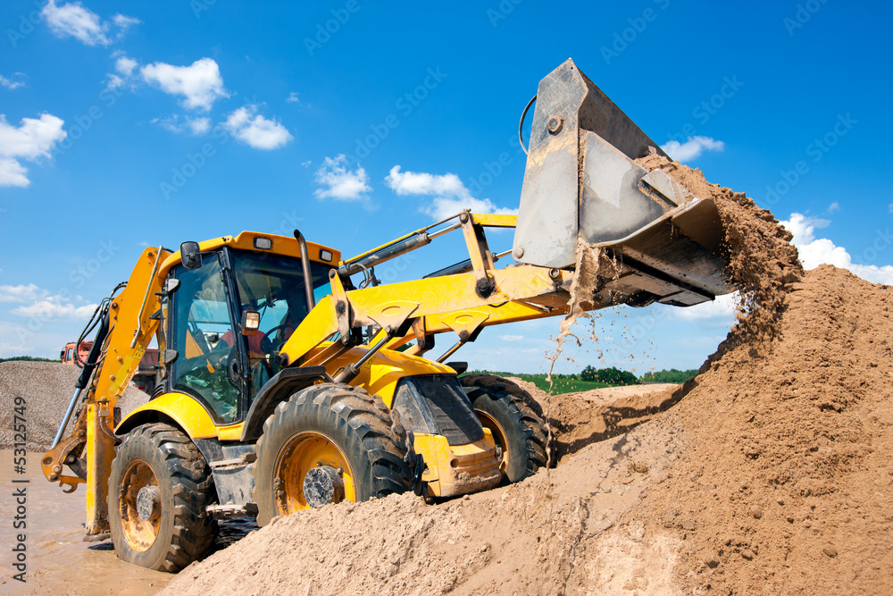 Excavator machine unloading sand during earth moving works - obrazy, fototapety, plakaty 