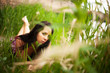 © Cara-Foto - Frau liegt am See auf der Wiese