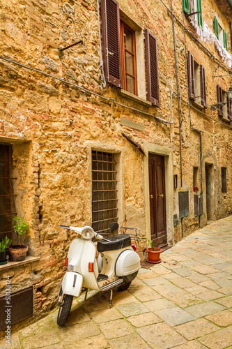 Obraz w ramie Vespa on a small street in the old town, Italy