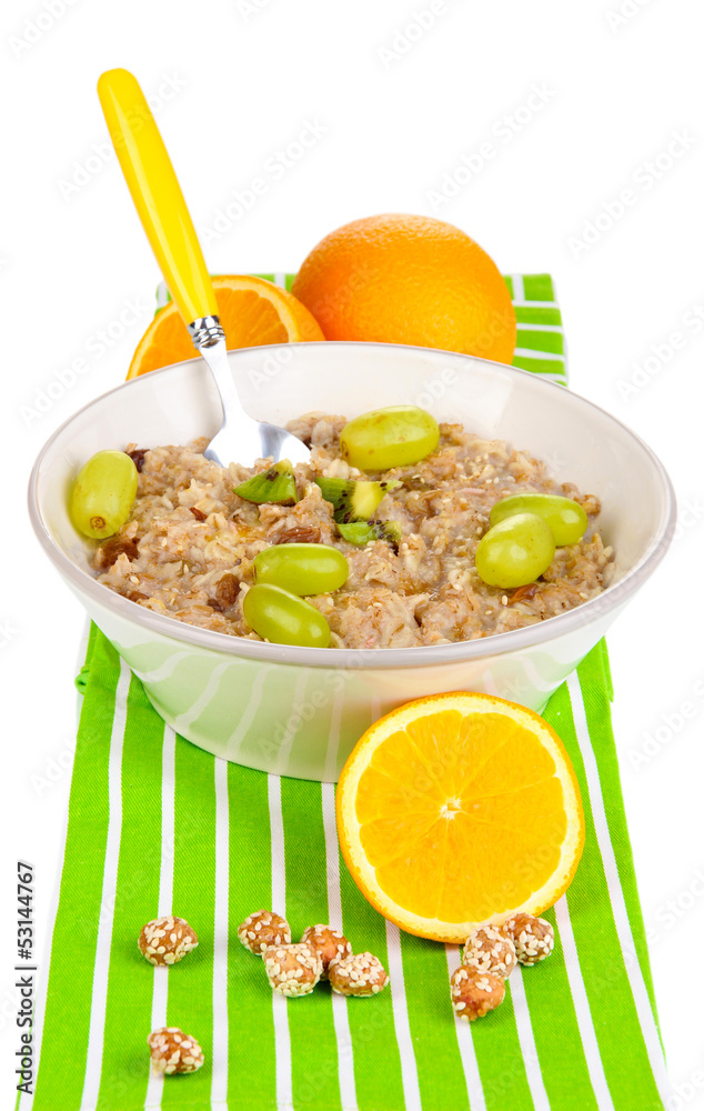 Useful oatmeal in bowl with fruit isolated on white