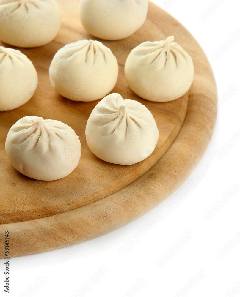 Raw khinkali on wooden desk, isolated on white