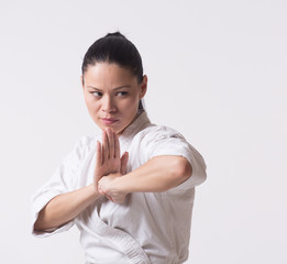 Woman in kimono show punch with elbow on white