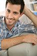 © goodluz - Portrait of handsome guy relaxing at home