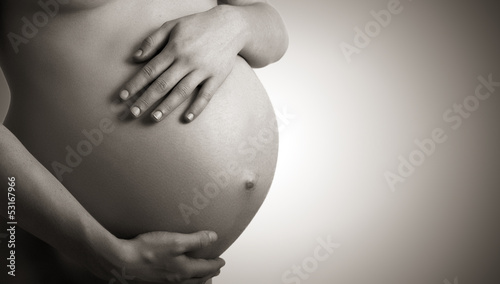 Fotomural belly of pregnant woman monochrome on dark background