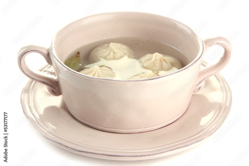 Tasty khinkali in .saucepan, isolated on white