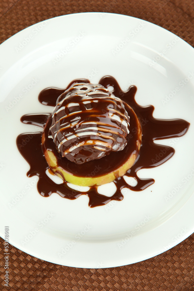 Chocolate dessert on big plate on brown napkin
