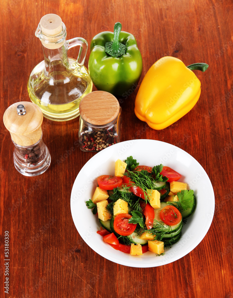 Light salad in plate on wooden table