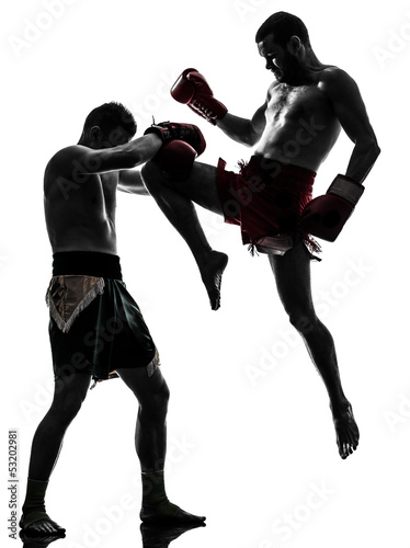 фотографія two men exercising thai boxing silhouette
