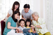 © szeyuen - Asian three generations family having fun with tablet computer