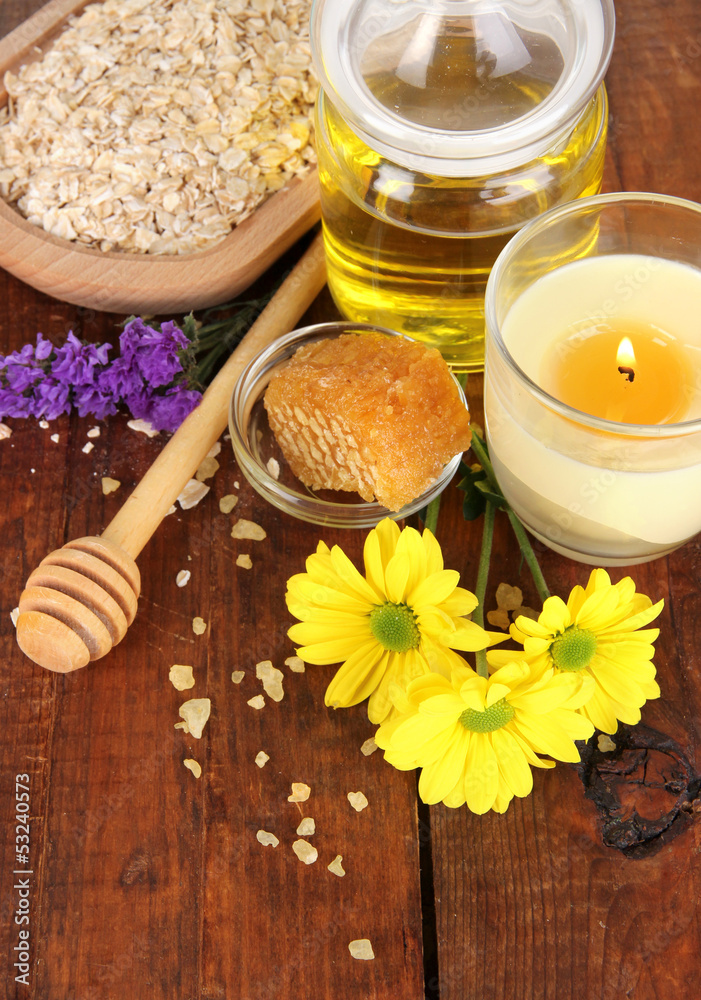 Fragrant honey spa with oils and honey on wooden table close-up