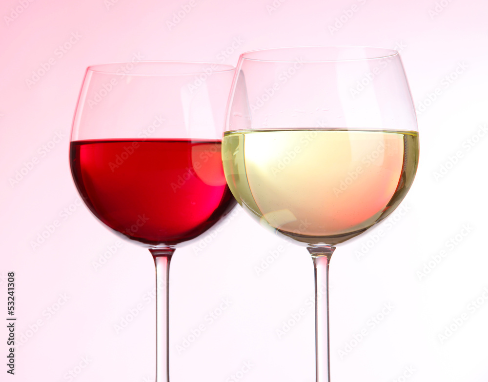Glasses of wine on light pink tone