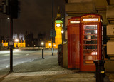 Fototapeta Londyn - Traditional red phone booth in London with the Big Ben in the ba