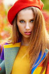 Sticker - Beautiful elegant woman standing in a park in autumn