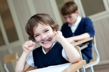 Wall Mural - Diligent student sitting at desk, classroom