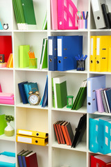 Wall Mural - White office shelves with different stationery, close up