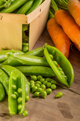 Wall Mural - Fresh shelled green peas and carrots