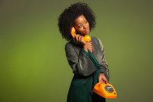 Retro 70s Afro Fashion Woman With Green Dress. Calling With Oran
