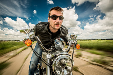 Fototapete - Biker racing on the road