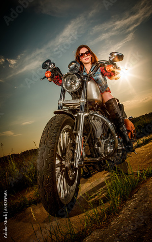 Obraz w ramie Biker girl sitting on motorcycle