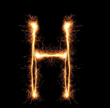 Letter "H" Sparklers On Black Background