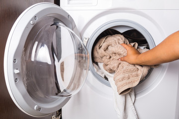 Hand loading laundry to the washing machine